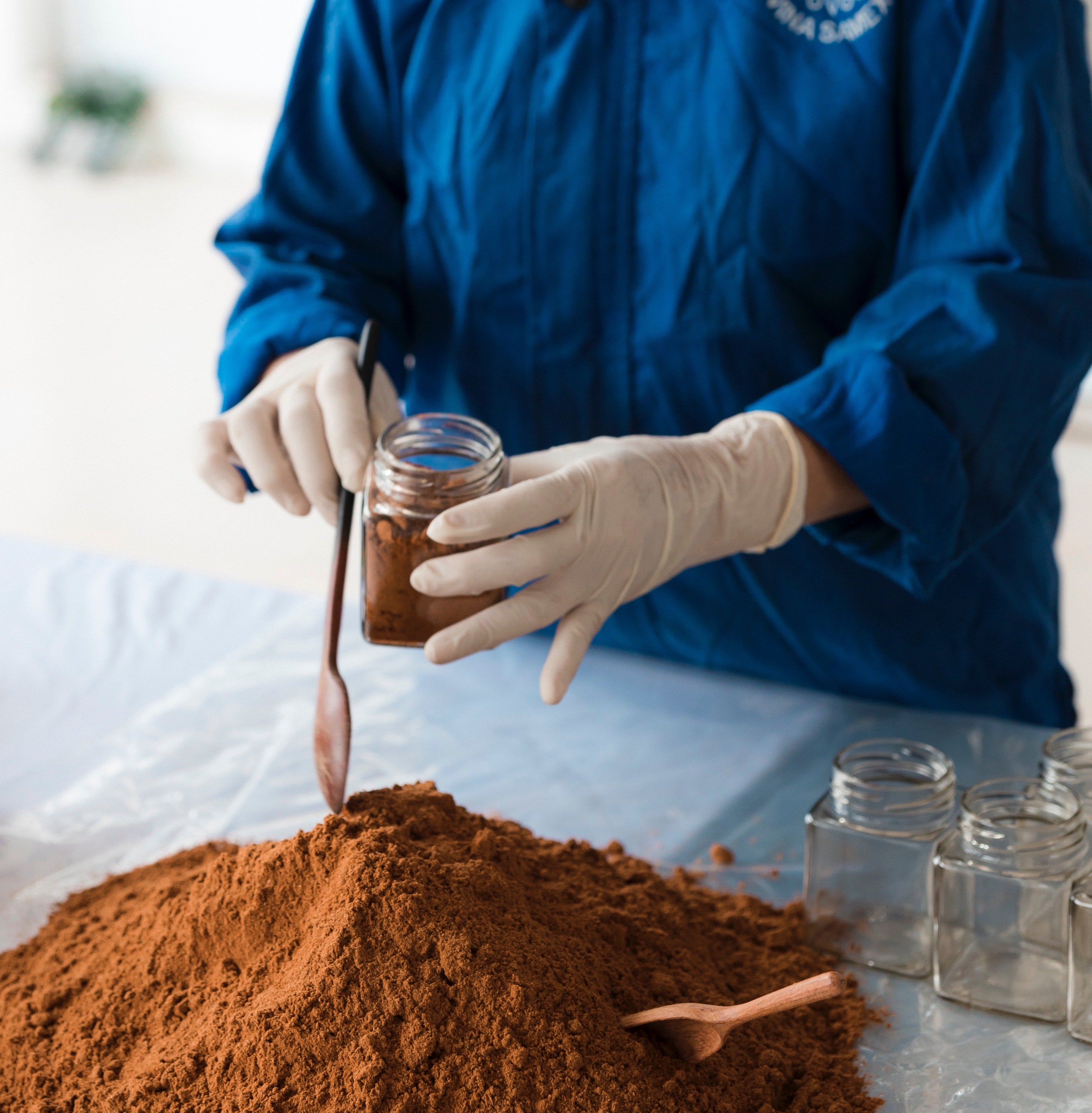 Lab Technician Collects Powdered Dietary Supplement Sample for Allergen Test